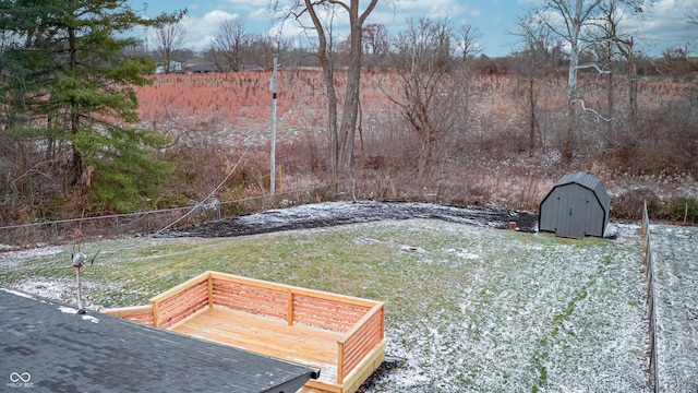 view of yard with a storage unit and a wooden deck