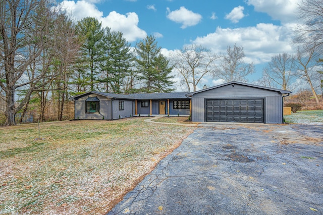 single story home featuring a front yard and a garage