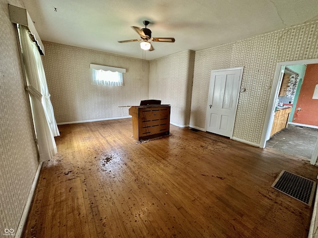 unfurnished bedroom featuring dark hardwood / wood-style floors and ceiling fan