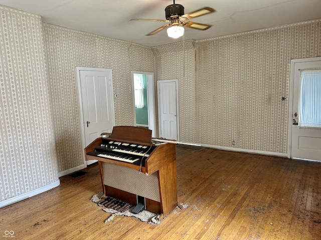 misc room with ceiling fan and wood-type flooring