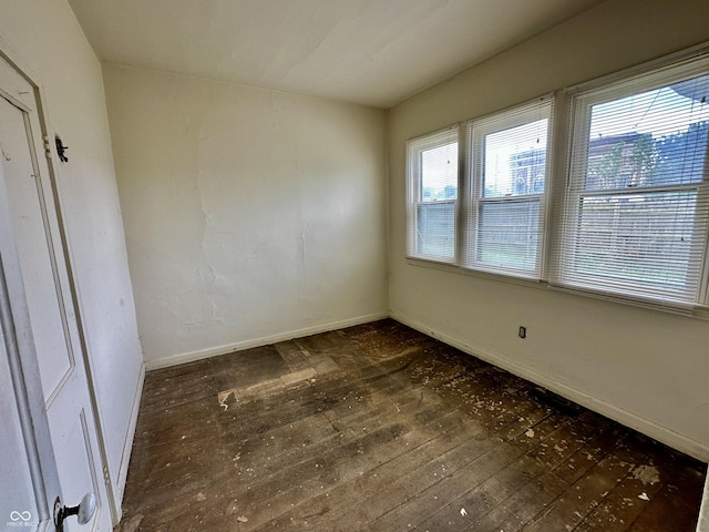 unfurnished room featuring dark wood-type flooring