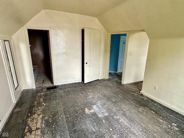 bonus room with dark hardwood / wood-style floors and lofted ceiling