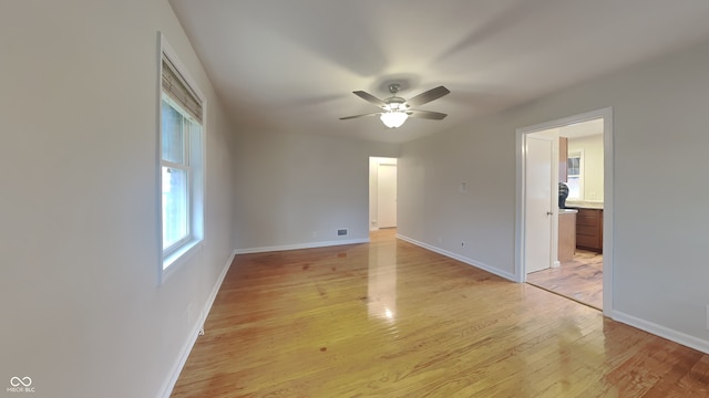 spare room featuring ceiling fan and light hardwood / wood-style floors