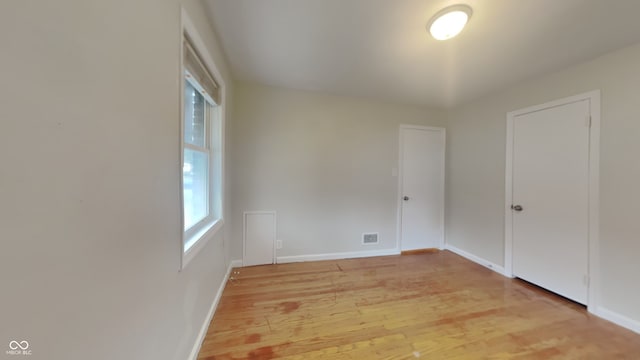 empty room with light hardwood / wood-style floors