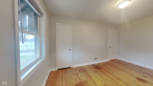 spare room with wood-type flooring