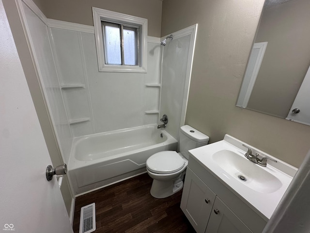 full bathroom featuring hardwood / wood-style flooring, vanity, toilet, and washtub / shower combination