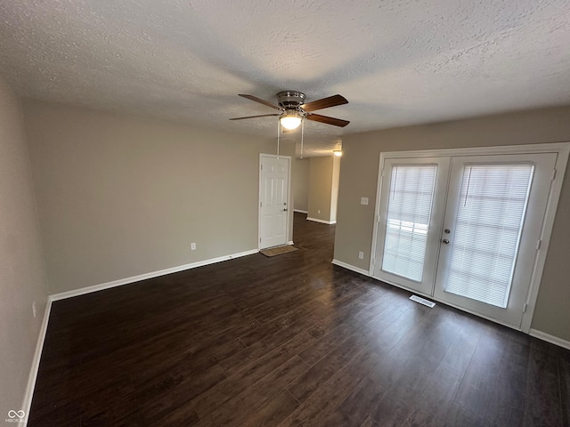 spare room with french doors, dark hardwood / wood-style flooring, a textured ceiling, and ceiling fan