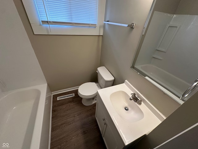 full bathroom featuring bathing tub / shower combination, vanity, hardwood / wood-style flooring, and toilet