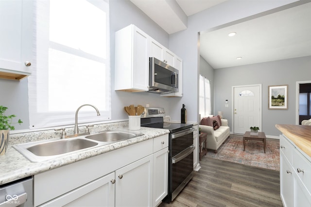 kitchen featuring white cabinetry, sink, dark hardwood / wood-style floors, and appliances with stainless steel finishes