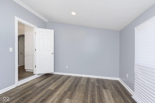 spare room with dark wood-type flooring