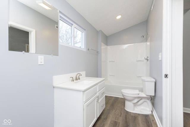 full bathroom with bathing tub / shower combination, hardwood / wood-style floors, lofted ceiling, toilet, and vanity