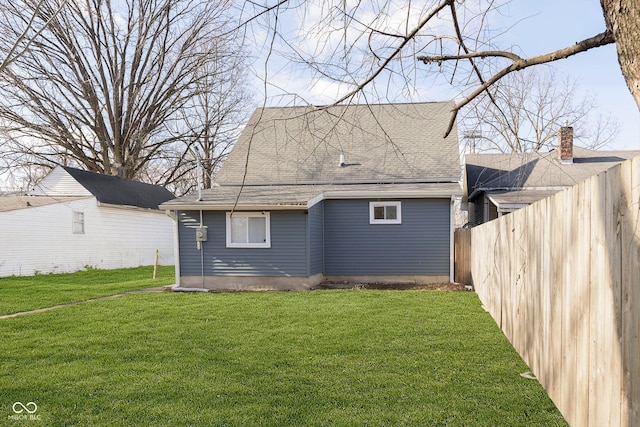 back of house with a lawn