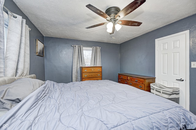 bedroom featuring a textured ceiling and ceiling fan