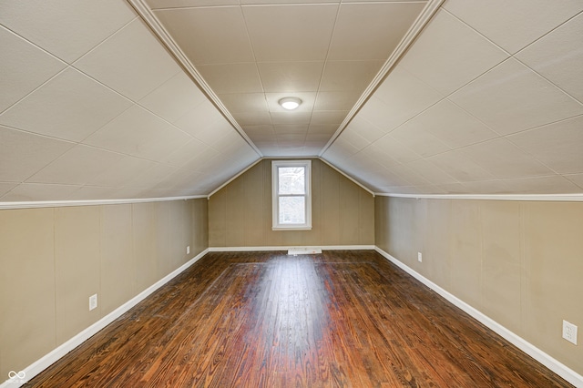 additional living space featuring lofted ceiling and dark wood-type flooring