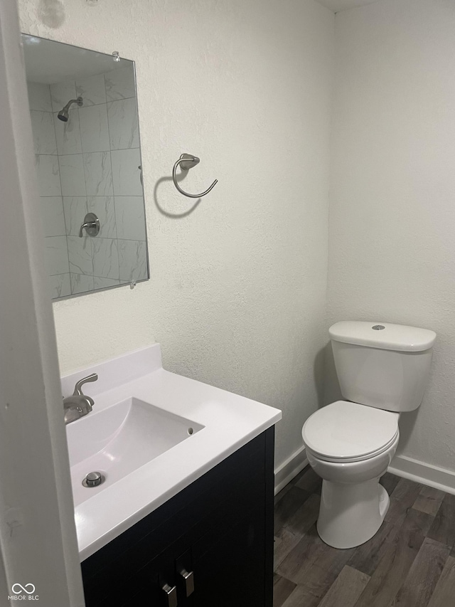 bathroom featuring hardwood / wood-style floors, vanity, and toilet