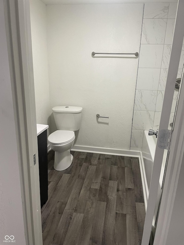 bathroom featuring vanity, hardwood / wood-style flooring, and toilet