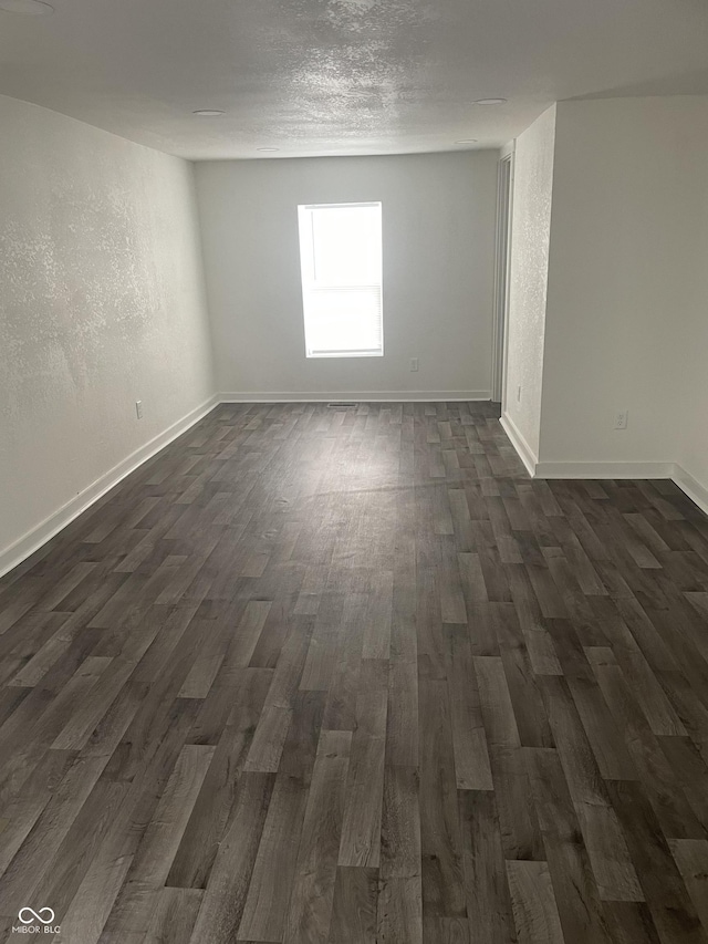 spare room featuring dark hardwood / wood-style floors