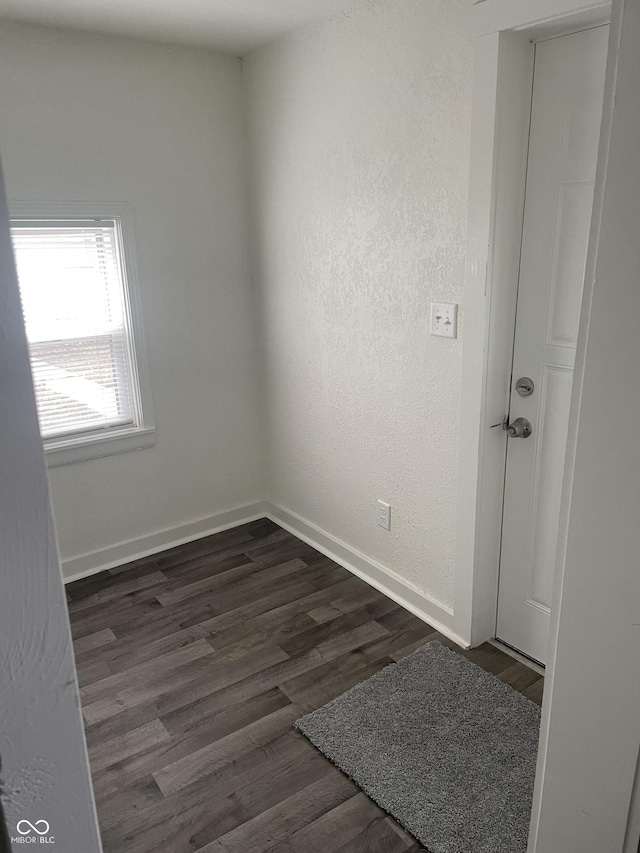 empty room with dark hardwood / wood-style floors