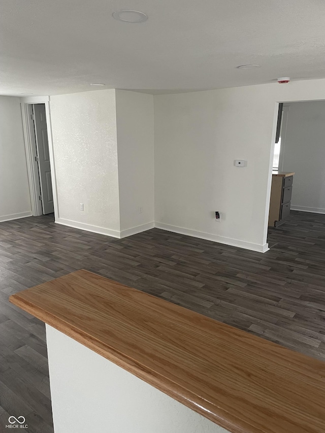 empty room featuring dark hardwood / wood-style flooring