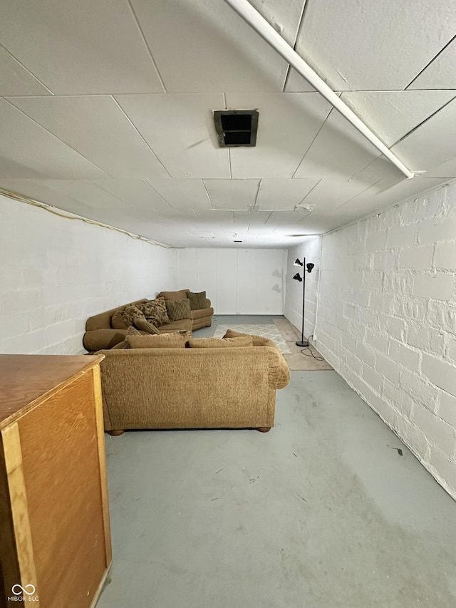 finished below grade area featuring concrete block wall