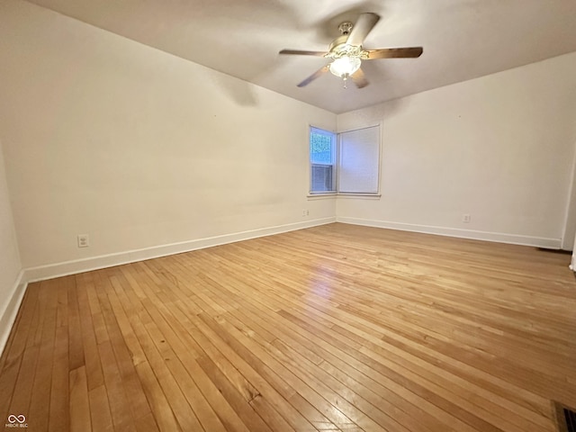 unfurnished room featuring baseboards, light wood-type flooring, and a ceiling fan