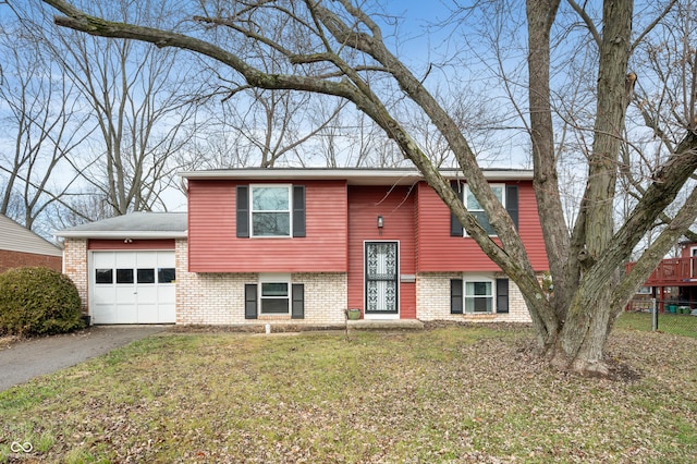 bi-level home with a front lawn and a garage