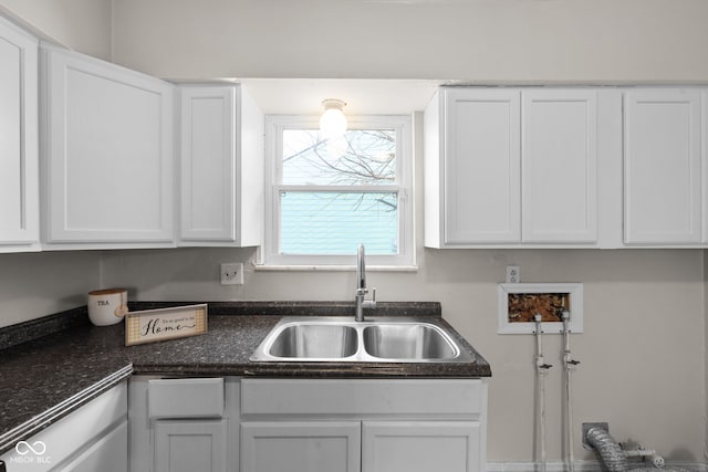 kitchen with white cabinetry and sink