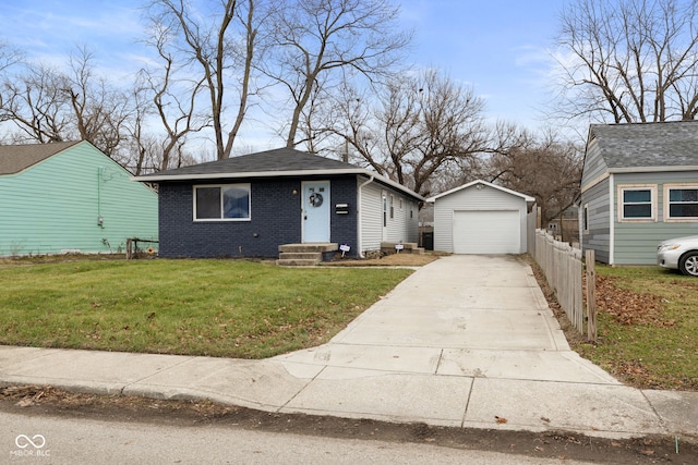 bungalow-style house with a garage, an outbuilding, and a front yard