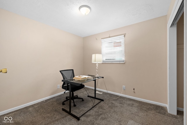 carpeted office with a textured ceiling