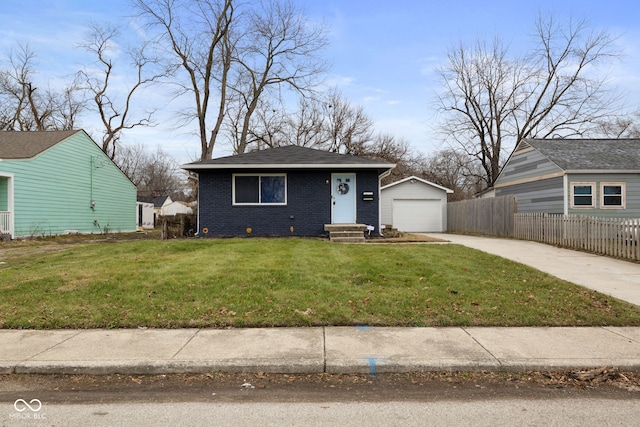 view of front of property with a front yard, a garage, and an outdoor structure