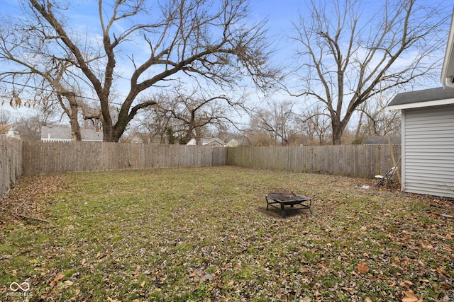 view of yard with a fire pit