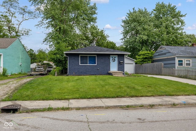 3125 N Tacoma Ave, Indianapolis, IN 46218 - view of front facade featuring driveway, brick siding, and a garage