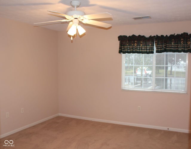 empty room with carpet flooring and ceiling fan