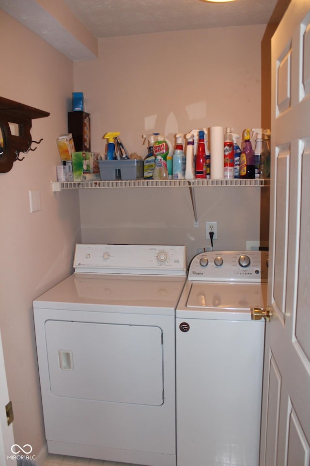 washroom featuring washer and dryer and a textured ceiling