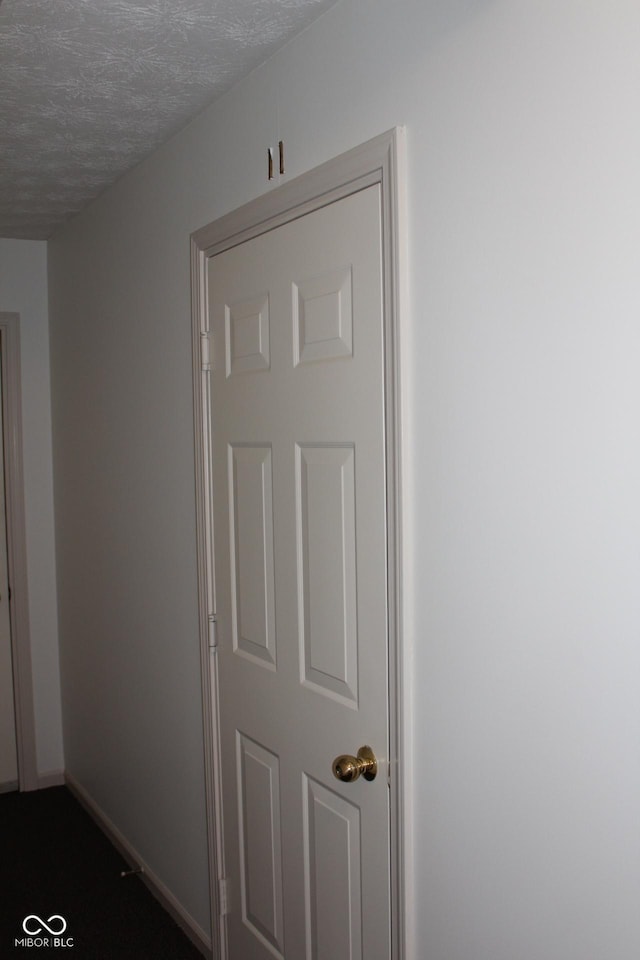 hallway featuring a textured ceiling