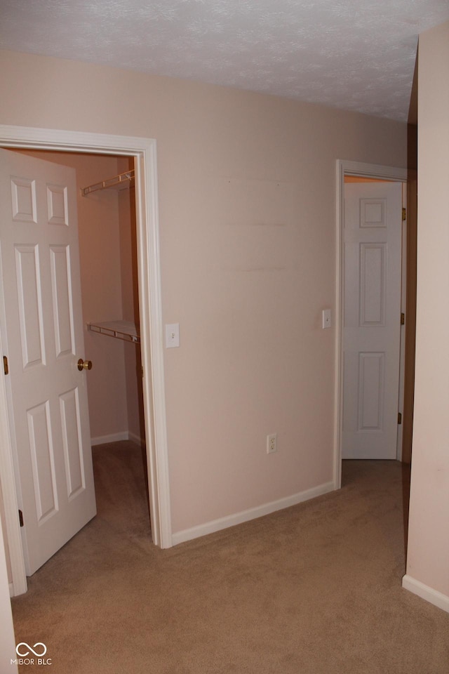 carpeted spare room featuring a textured ceiling