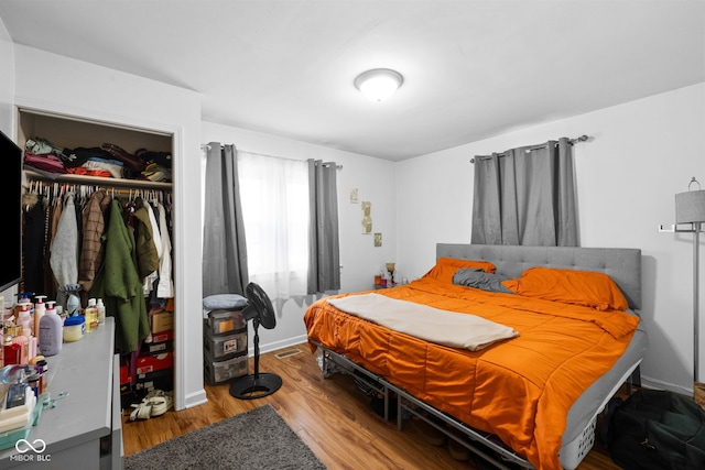 bedroom with wood-type flooring and a closet