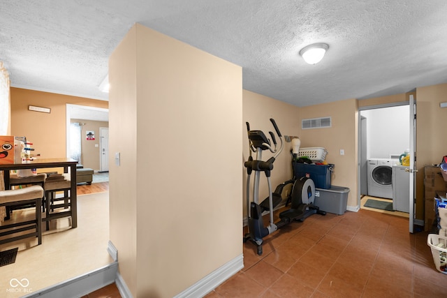 interior space with washer / dryer and a textured ceiling