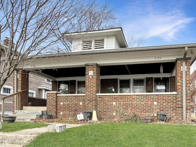 bungalow-style house with a front lawn and a porch