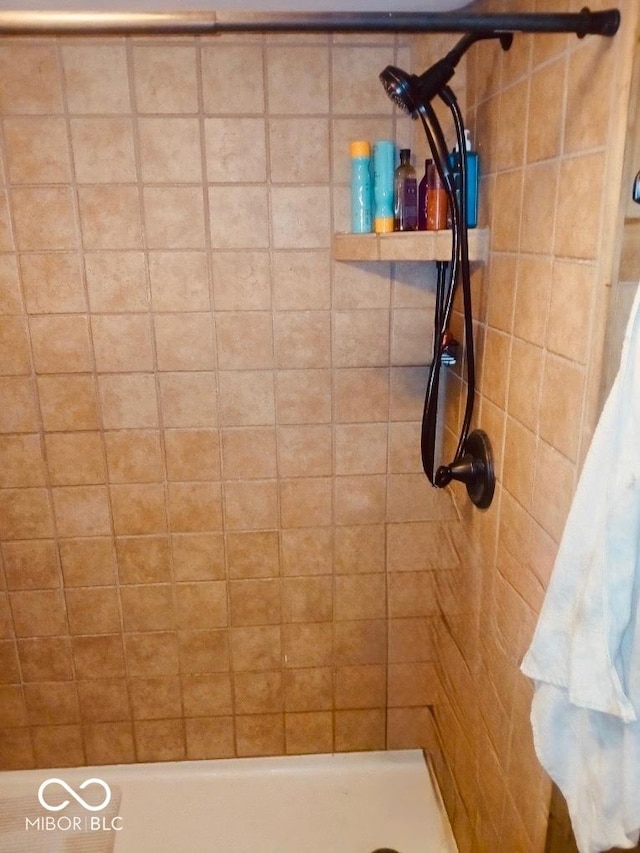 bathroom with a tile shower