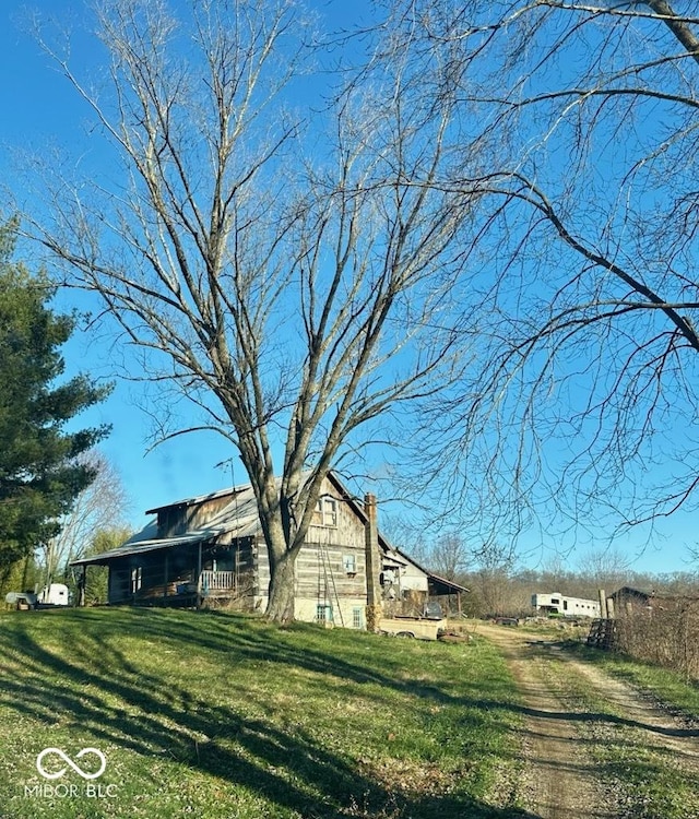 view of side of home with a lawn