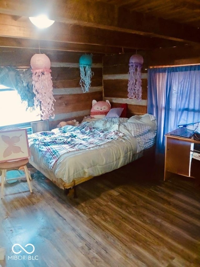 bedroom with hardwood / wood-style flooring and wooden walls