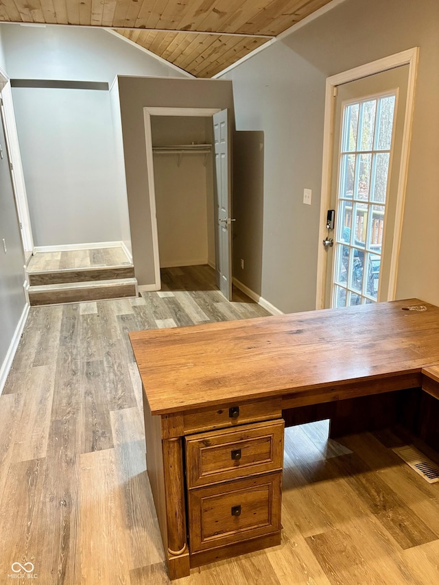 interior space with lofted ceiling, light hardwood / wood-style flooring, and wooden ceiling