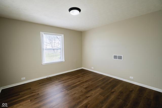 unfurnished room with dark hardwood / wood-style flooring