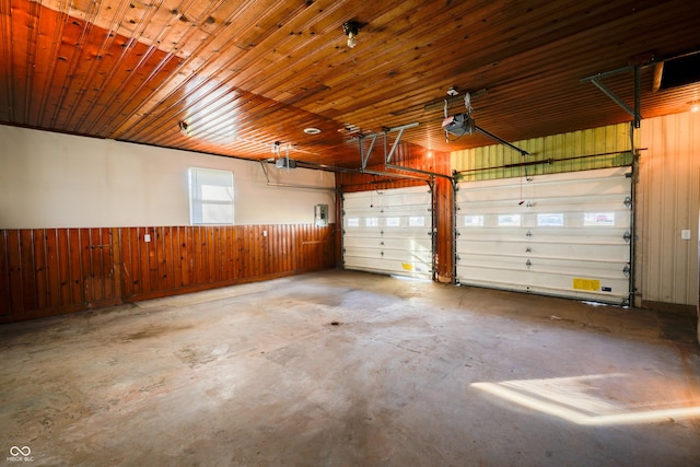 garage featuring a garage door opener, wooden ceiling, and wood walls