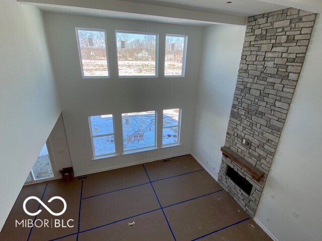 unfurnished living room featuring a fireplace and tile patterned flooring