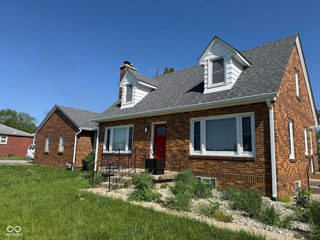 3192 E Main St, Plainfield, IN 46168 - cape cod house featuring brick siding, a chimney, a front lawn, and roof with shingles