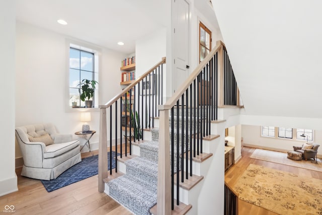 staircase with hardwood / wood-style flooring