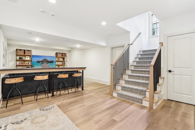 bar with light hardwood / wood-style flooring