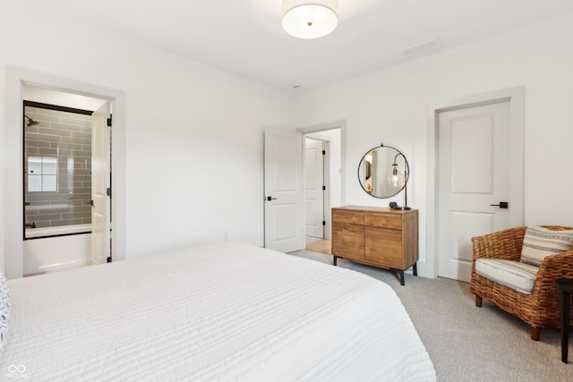 carpeted bedroom featuring connected bathroom